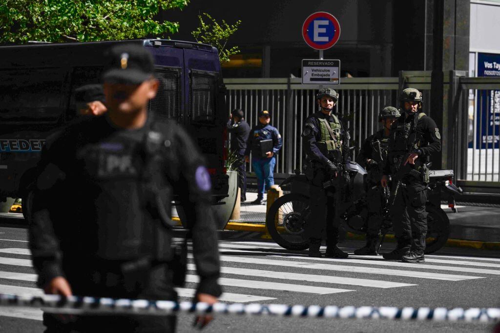 Federal Police officers stand guard on Mayo Avenue during a security operation around the Israeli embassy in Buenos Aires following a bomb threat, on October 18, 2023.