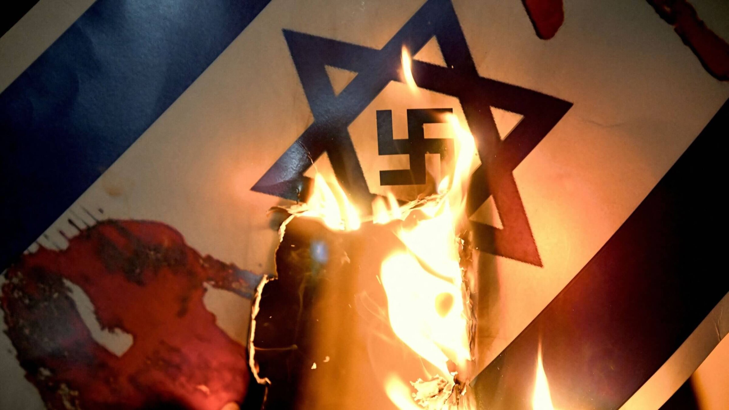 Protesters burned a placard representing an Israeli flag with a Nazi swastika inside the Star of David during a rally in support of Palestinians outside the Israeli Consulate in Istanbul earlier this month. 
