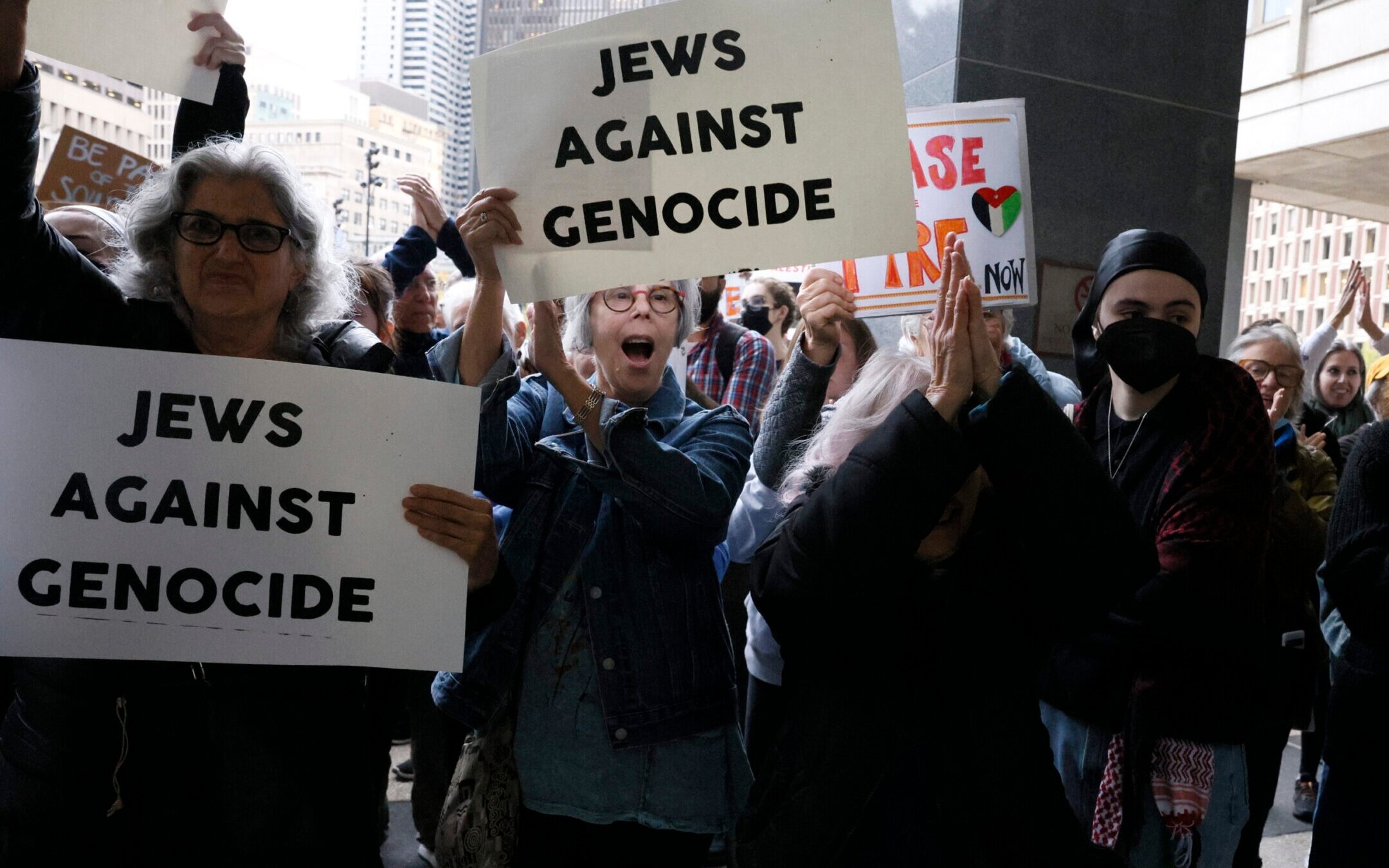 Protesters cheer as they rally outside of the John F. Kennedy Federal Building in support of six Jewish protesters who were stopped inside the hallway while trying to get to Sen. Elizabeth Warren’s office where they had planned to stage a sit in and “call for U.S. action to prevent genocide in Gaza,” Oct. 18. 2023. 