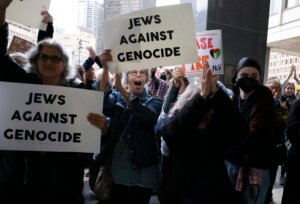 Protesters cheer as they rally outside of the John F. Kennedy Federal Building in support of six Jewish protesters who were stopped inside the hallway while trying to get to Sen. Elizabeth Warren’s office where they had planned to stage a sit in and “call for U.S. action to prevent genocide in Gaza,” Oct. 18. 2023. 
