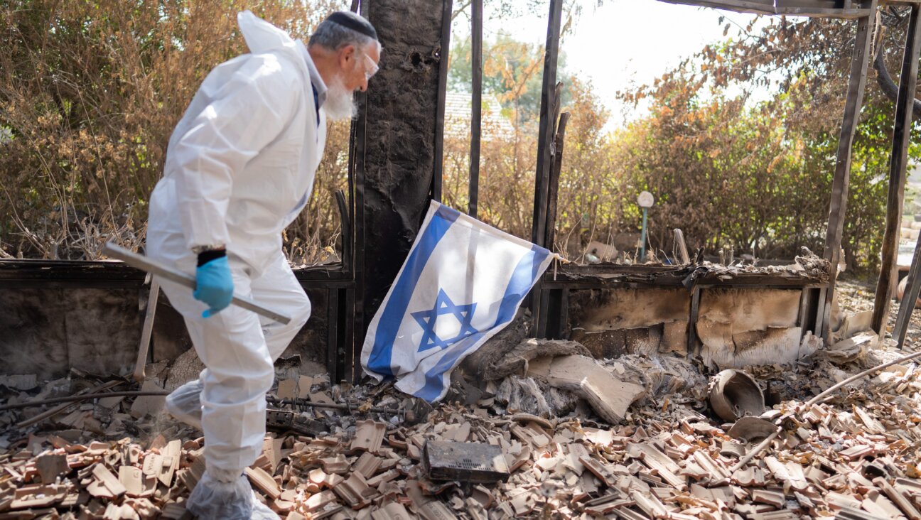 A member of Zaka collects the remains of people killed by Hamas terrorists in Kibbutz Be'eri, a small town in southern Israel near the border with Gaza, October 20, 2023 