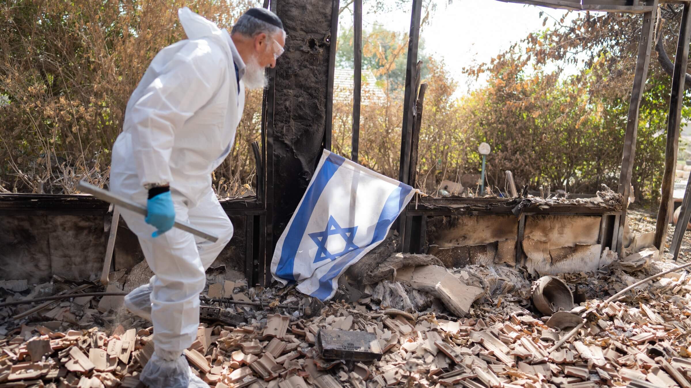 A member of Zaka collects the remains of people killed by Hamas terrorists in Kibbutz Be'eri, a small town in southern Israel near the border with Gaza, October 20, 2023 