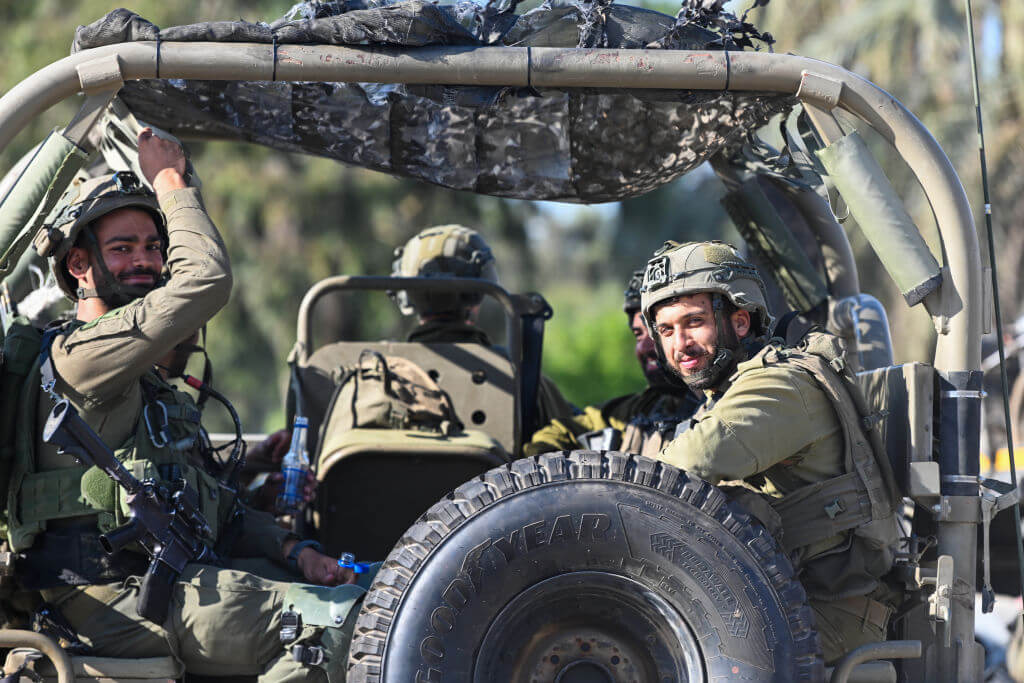 IDF soldiers drive in military vehicles on October 15, 2023 in Sderot, Israel.