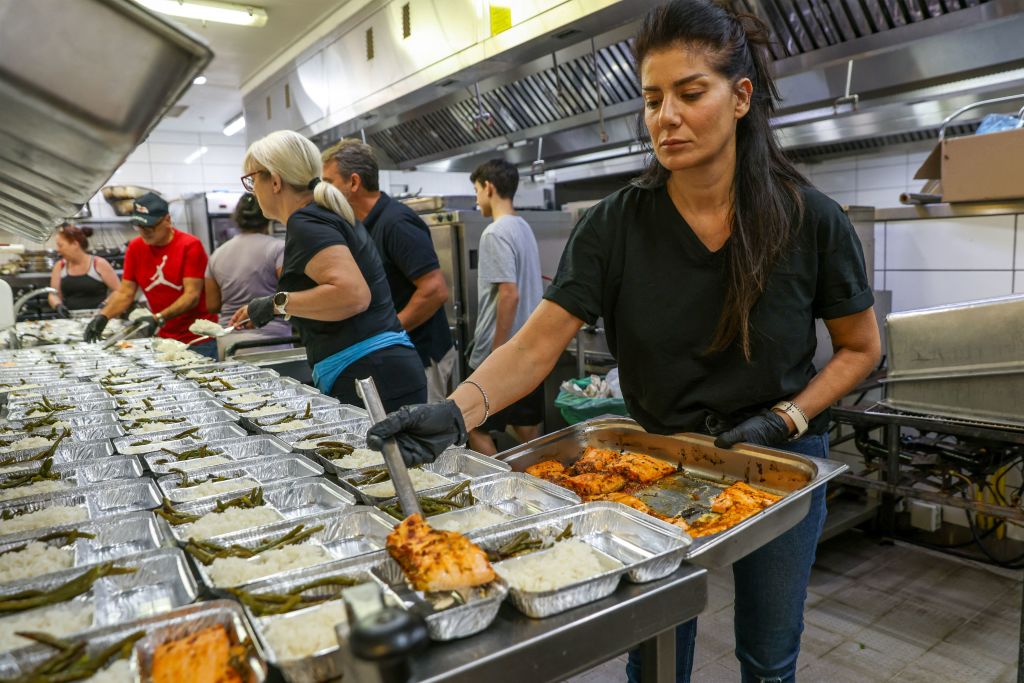 Volunteers prepare food for Israeli soldiers on Monday near the border with Lebanon. (Getty)