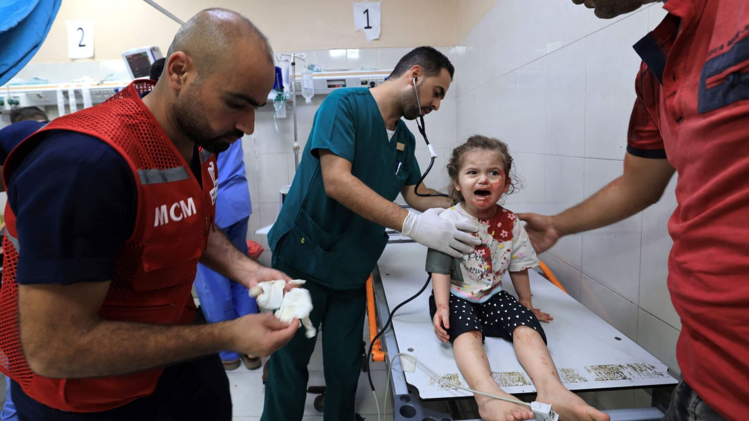 Mahmud al-Astal, a Palestinian nurse, attends to a little girl with a head wound at Gaza's Nasser hospital after Israeli airstrikes on Khan Yunis in the southern Gaza Strip on Friday.