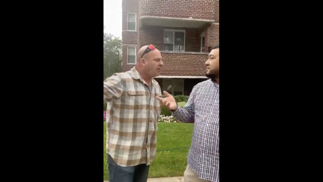 A man confronts another man who was filmed removing Israeli hostage posters on a street corner in Queens, according to video shared by the watchdog group StopAntisemitism. (X)