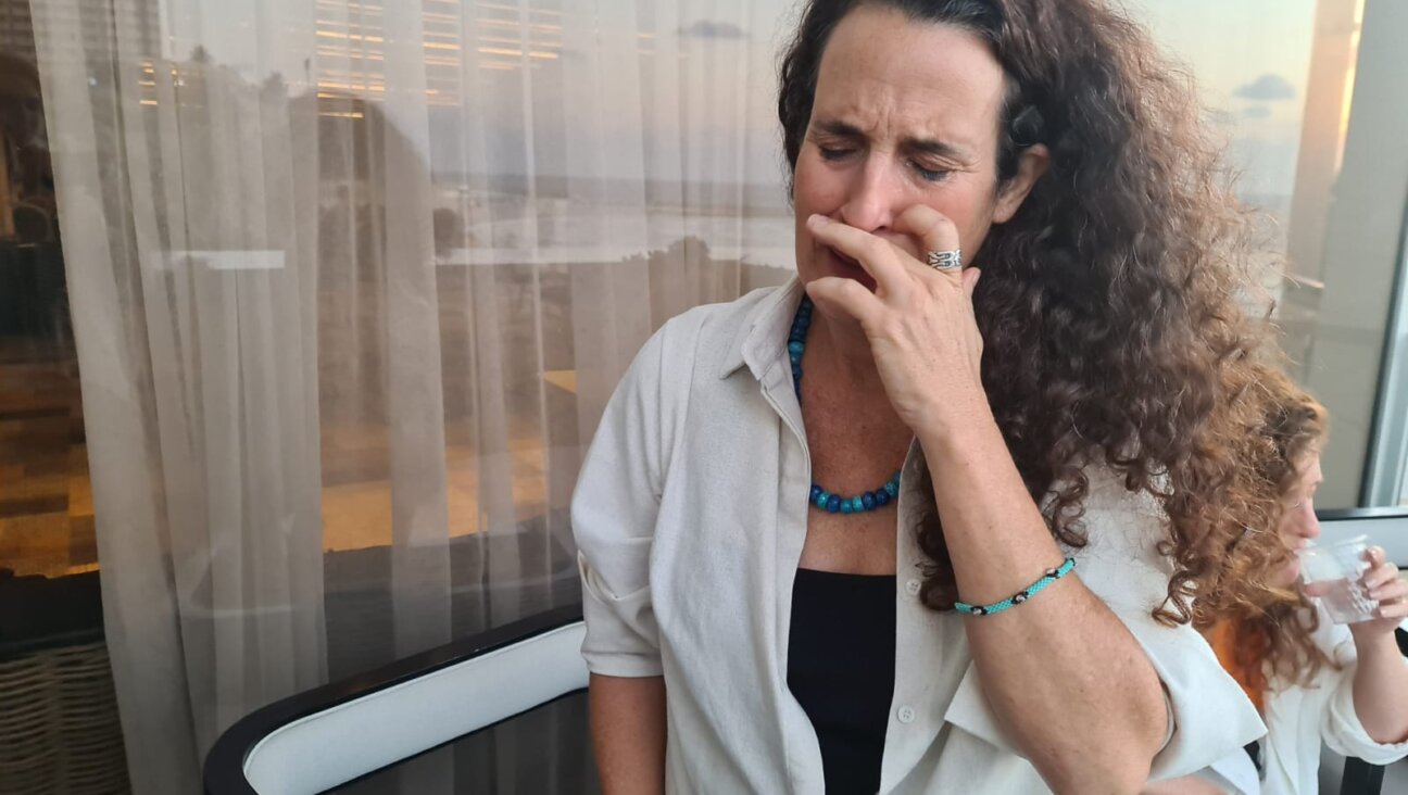 Hadas Calderon weeps as she thinks about her children, 16 and 12, who she was told are captives in Gaza with their father, her ex-husband, Oct. 19, 2023. (Deborah Danan)