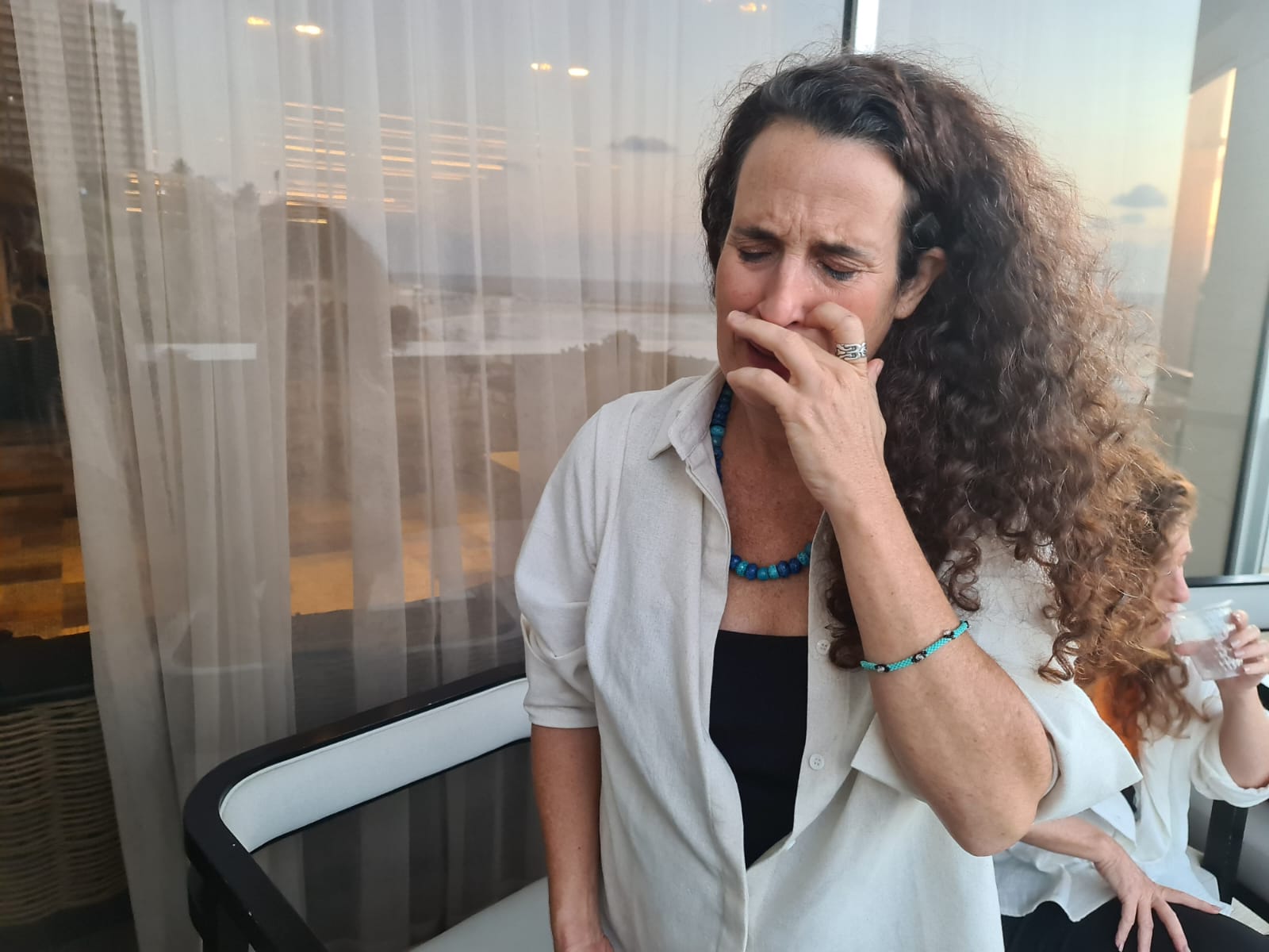 Hadas Calderon weeps as she thinks about her children, 16 and 12, who she was told are captives in Gaza with their father, her ex-husband, Oct. 19, 2023. (Deborah Danan)