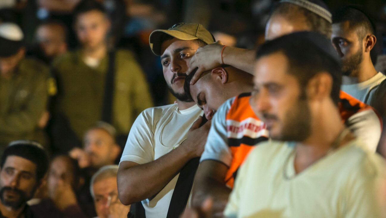 Family and friends of fallen IDF soldier Amit Zur, who died in a battle with Hamas gunmen, react during his funeral in Eliayachin, Israel on Oct. 10, 2023. (Amir Levy/Getty Images)