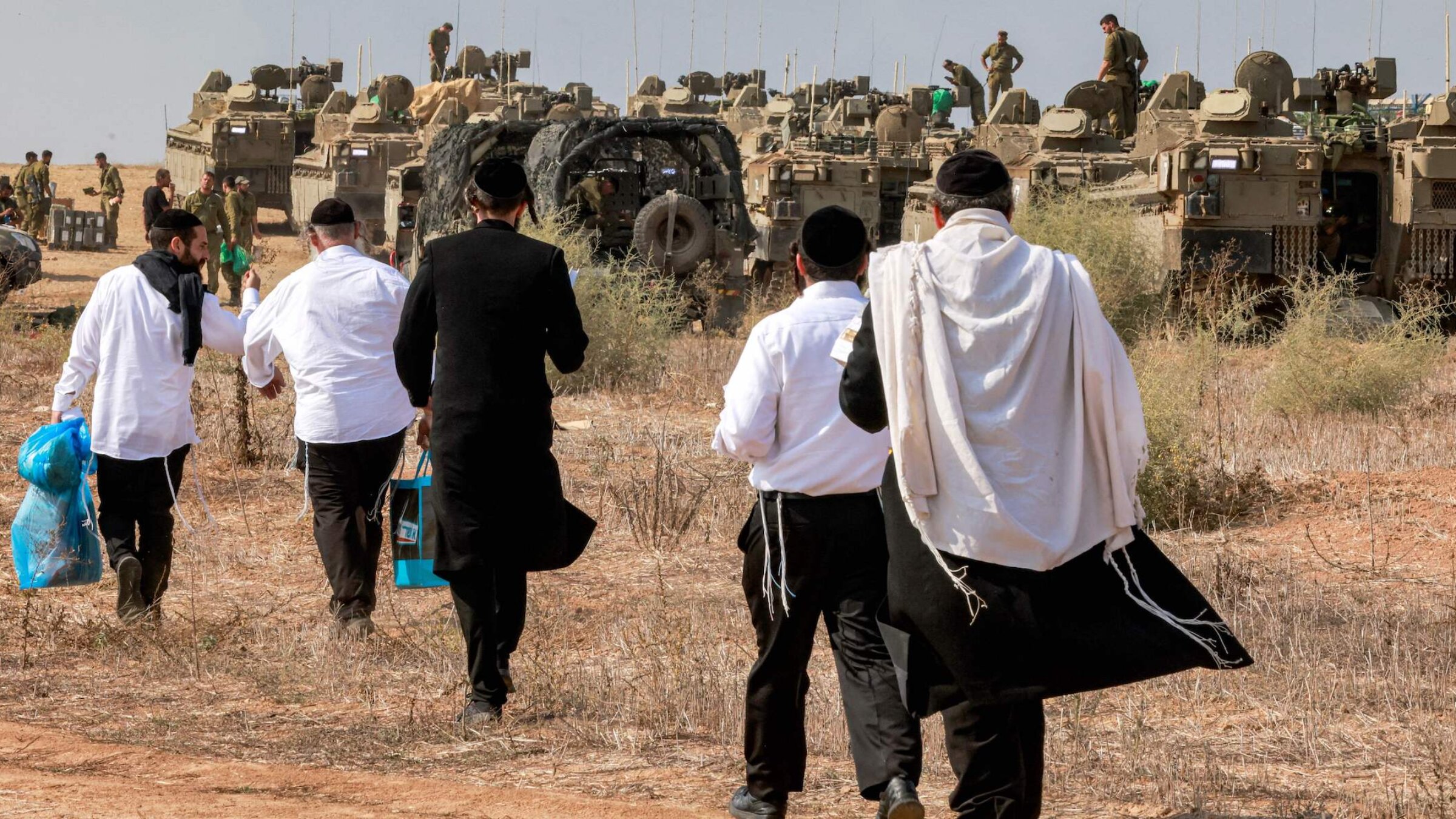 Haredi Jews visit Israeli soldiers to show their support as they deploy at a position near the border with Gaza in Southern Israel on Oct. 11.