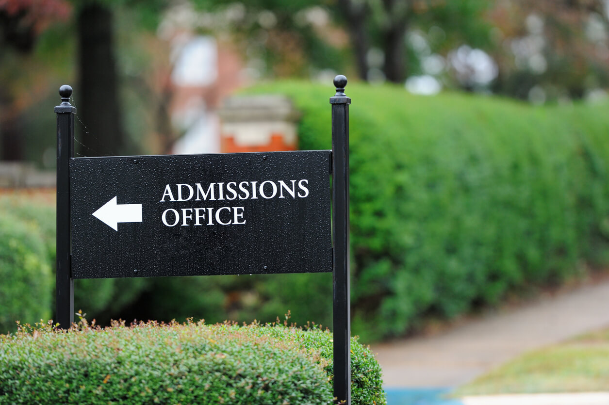Close up of admissions office sign near public university campus.