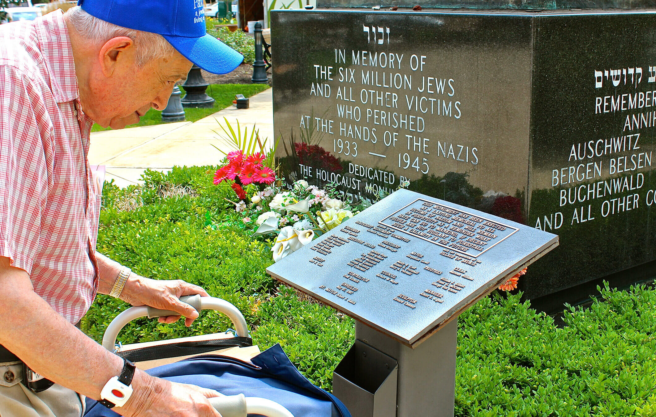 Holocaust survivor Larry Heimlich reads a plaque at the Holocaust Monument in Skokie, Illinois, in 2014.