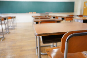 A classroom with an empty school desk.