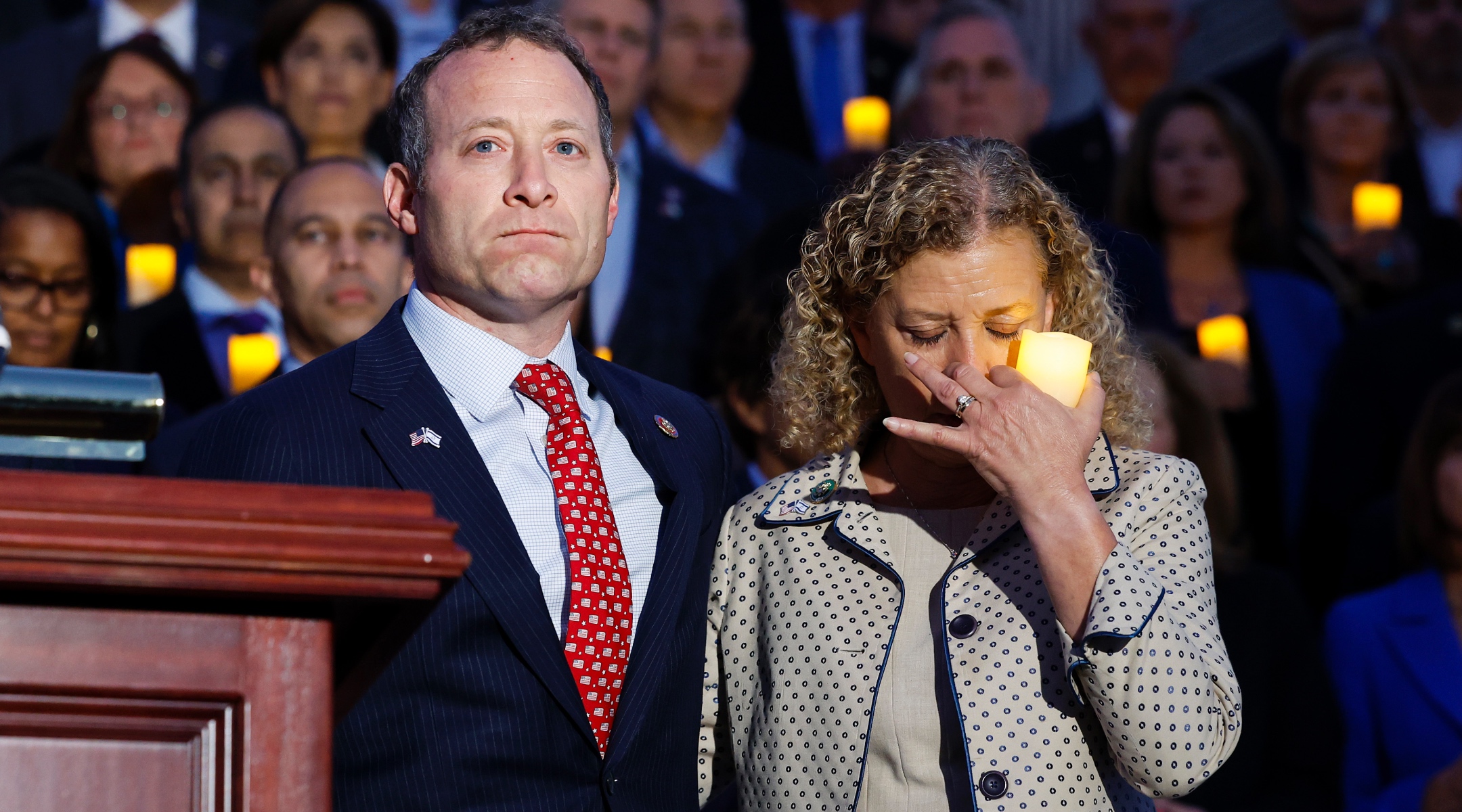 Rep. Josh Gottheimer, a New Jersey Democrat, and Rep. Debbie Wasserman Schultz, a Florida Democrat, listen as Margaret Grun Kibben, the chaplain of the U.S. House of Representatives, leads a prayer during a vigil for Israel on the steps of the U.S. Capitol Building, Oct. 12, 2023. (Anna Moneymaker/Getty Images)