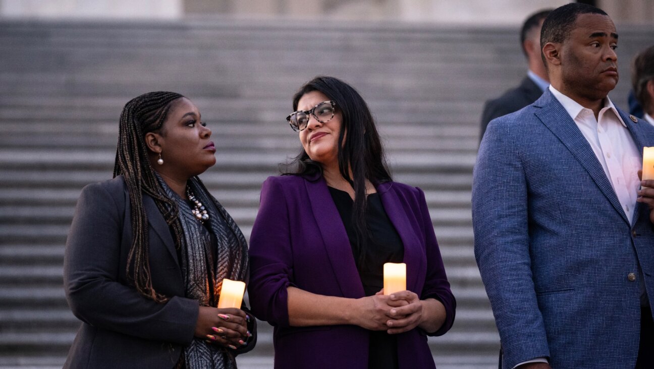 Reps. Cori Bush, a Missouri Democrat, and Rashida Tlaib, a Michigan Democrat, attend talk with each other as they attend a bipartisan candlelight vigil with members of Congress to commemorate one month since the Hamas terrorist attacks in Israel on October 7, at the U.S. Capitol, Nov. 7, 2023 (Drew Angerer/Getty Images)