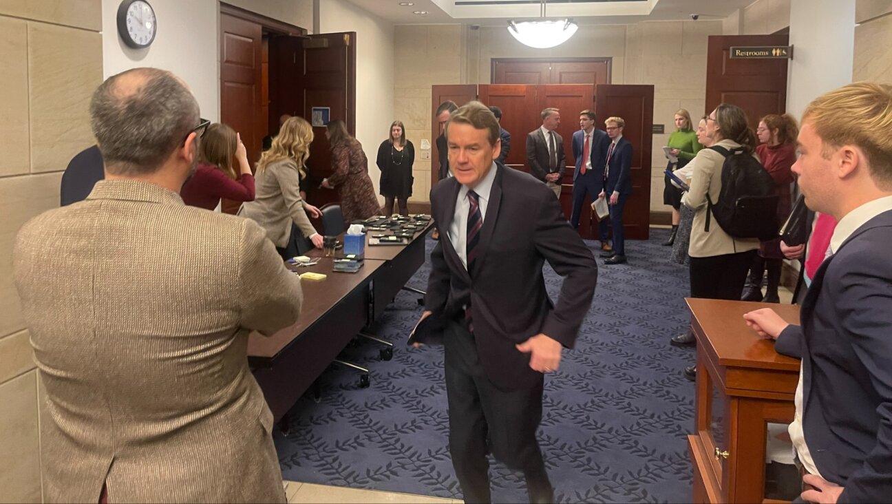 Sen. Michael Bennet, a Colorado Democrat, runs out of a Senate room where there was a screening of the Oct. 7 Hamas atrocities, in the U.S. Capitol, Nov. 28, 2023. (Ron Kampeas)