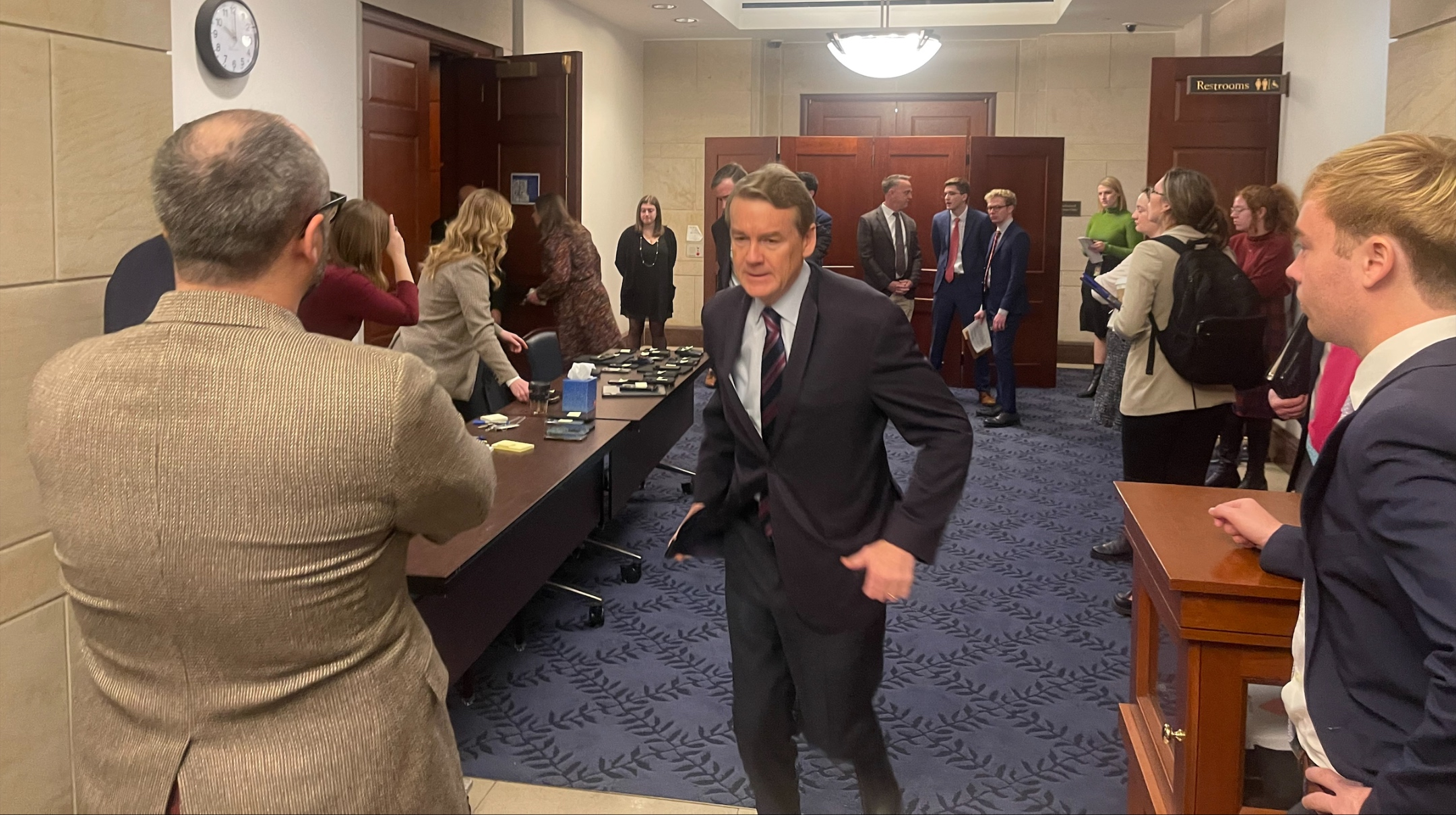 Sen. Michael Bennet, a Colorado Democrat, runs out of a Senate room where there was a screening of the Oct. 7 Hamas atrocities, in the U.S. Capitol, Nov. 28, 2023. (Ron Kampeas)
