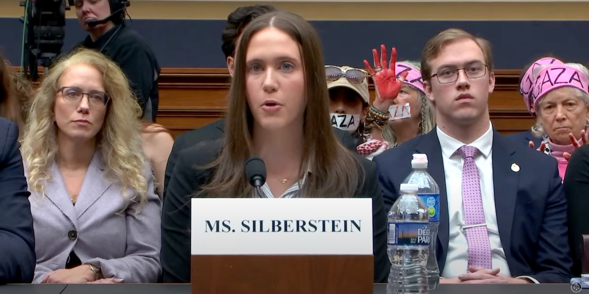 Amanda Silberstein, a Jewish Cornell University student, testifies before the U.S. House on the antisemitism she has experienced on campus as pro-Palestinian protesters demonstrate behind her, Washington, D.C., Nov. 8, 2023. (Screenshot via YouTube)