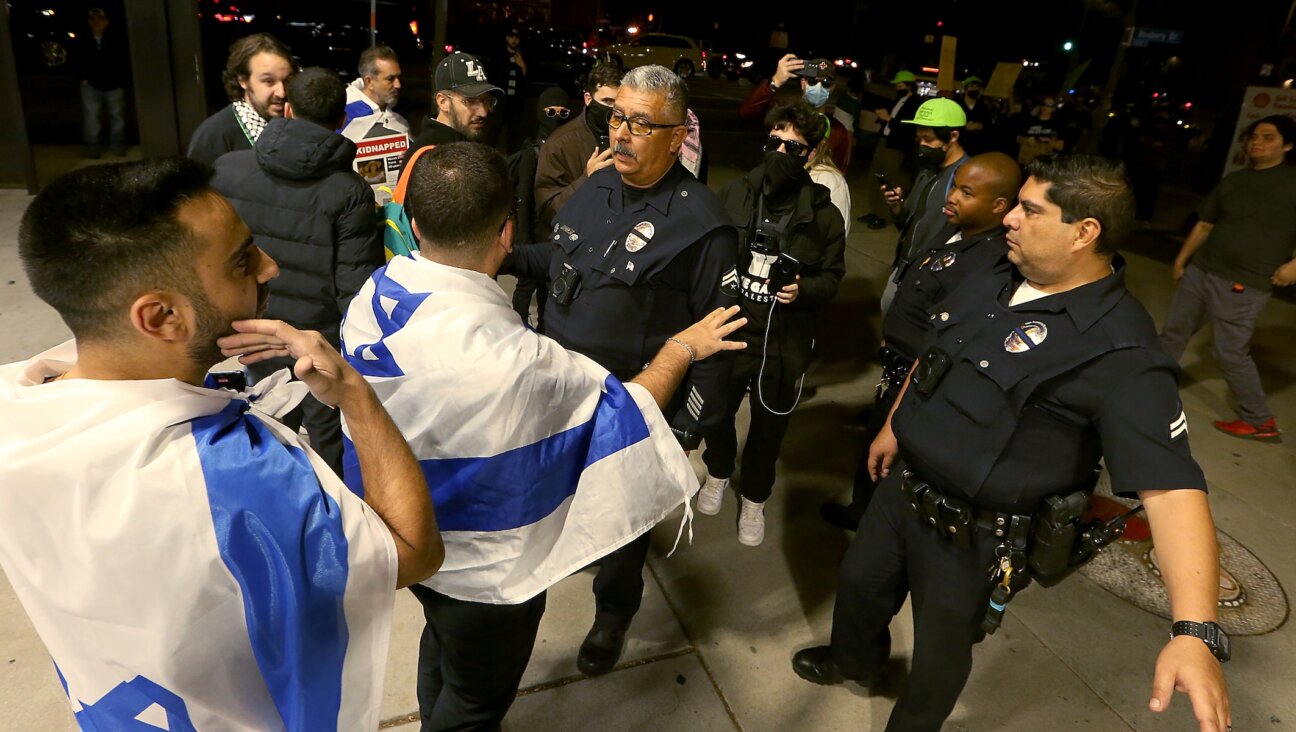 LAPD officers get between pro-Israel and pro-Palestinian activists outside The Museum of Tolerance in Los Angeles on Wednesday, Nov. 8, 2023. The museum held a private screening of footage documenting the Hamas invasion of Israel on Oct. 7th. Supporters of Palestine protested across the street outside. (Luis Sinco / Los Angeles Times via Getty Images)