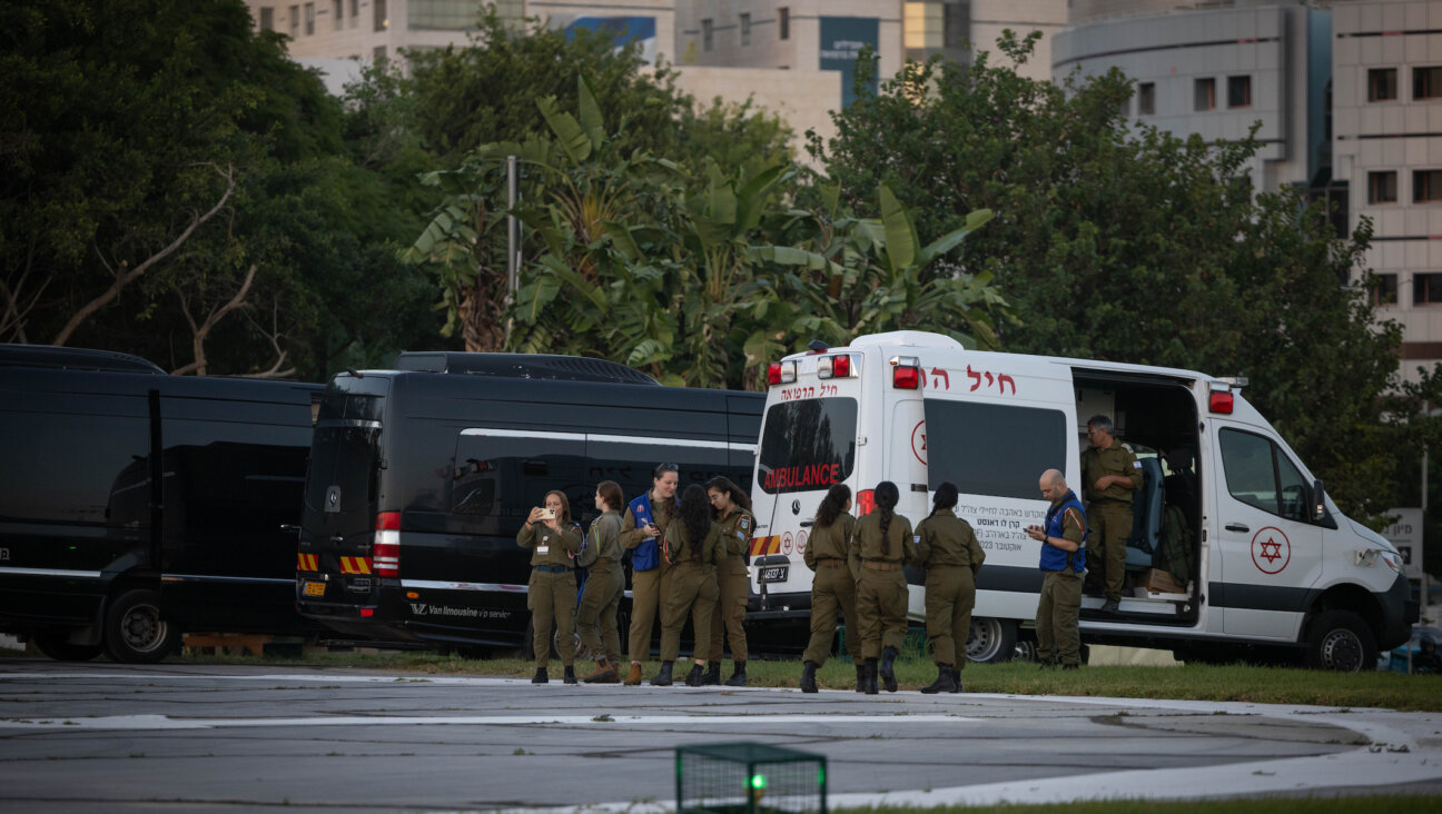 Israeli soldiers wait for the arrival of Israeli hostages at the Schneider Children’s Medical Center in Petah Tikva, Nov. 24, 2023. (Yonatan Sindel/Flash90)