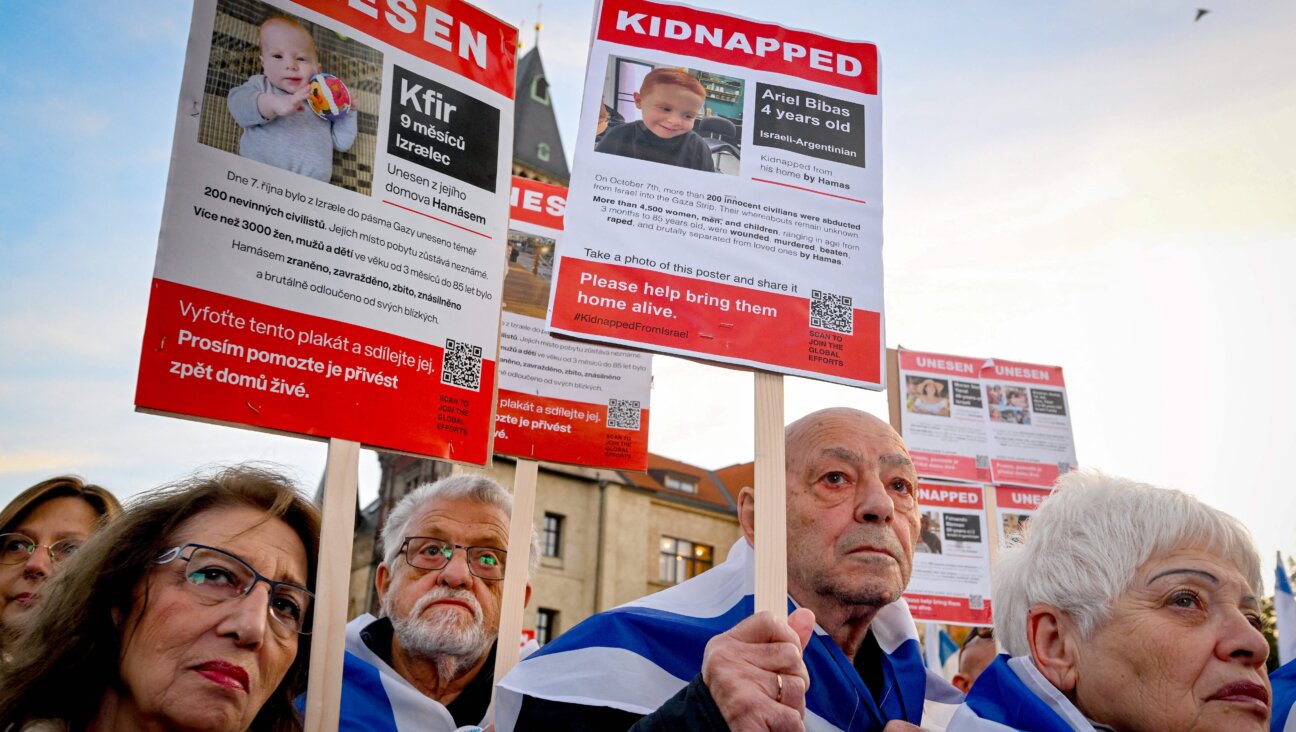 Demonstrators  in Prague hold up placards with images of Kfir (<i>left</i>) and Ariel (<i>right</i>) Bibas, young children who were kidnapped in the Oct. 7 terror attacks in southern Israel.