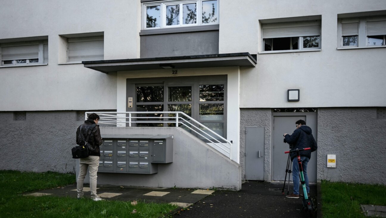 Police photograph the outside of a home in Lyon, France, where a Jewish woman was stabbed, Nov. 5, 2023. (Jeff Pachoud/AFP via Getty Images)