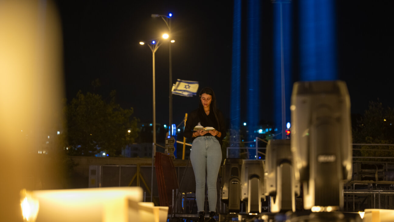  A woman prays while visiting the Lights of Hope installation in Jerusalem.