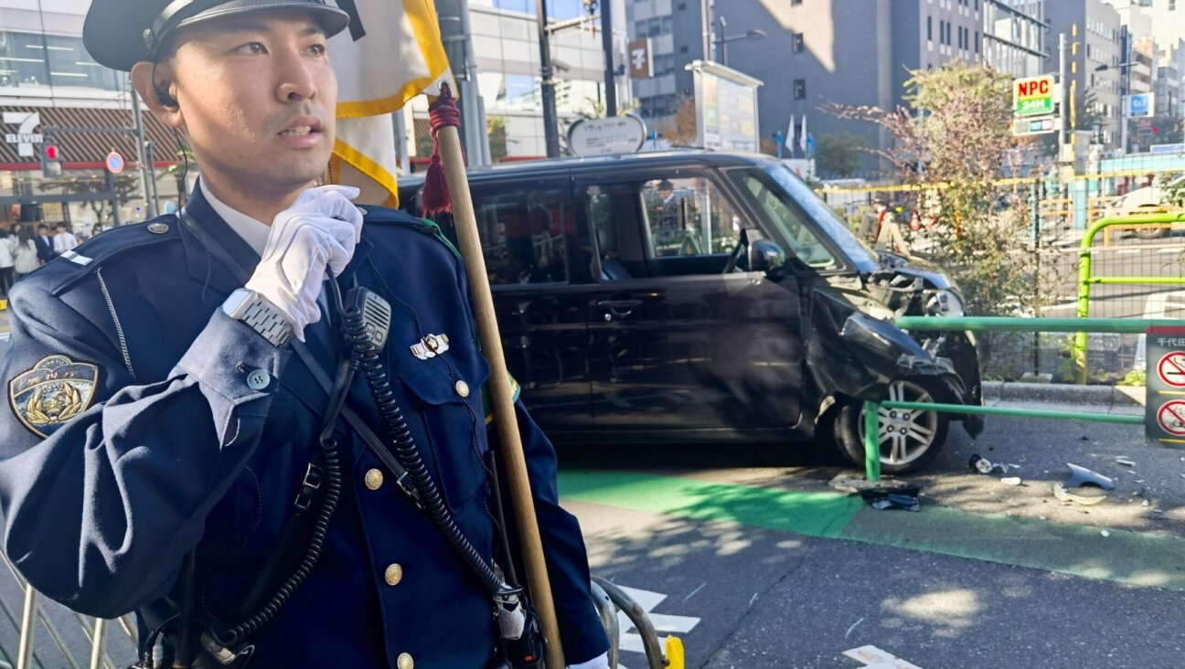 A police officer on duty at the scene of a car crash near the Israeli Embassy in Tokyo, Japan, Nov. 16, 2023. ( Zhong Ya/Xinhua via Getty Images)