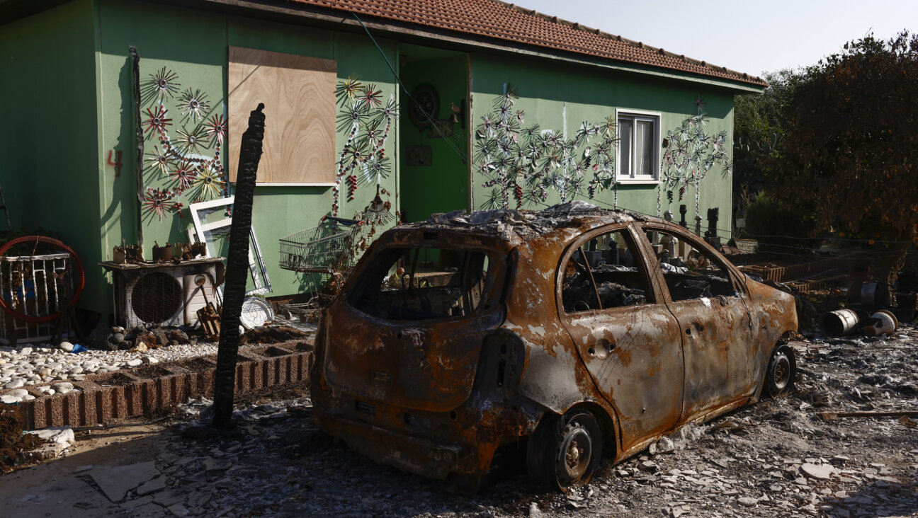 A burned out vehicle outside a home following the Oct. 7 Hamas attacks.
