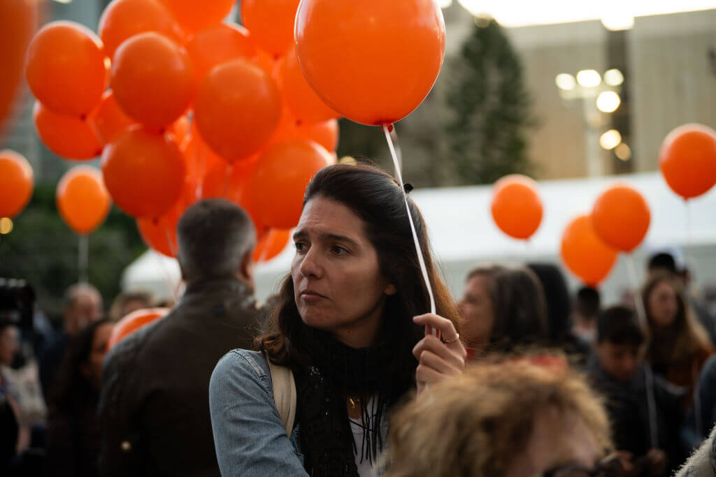 Relatives of the Bibas family and their supporters participate in a rally calling for the immediate release of Yarden Bibas, Shiri Bibas, and their two children, Ariel, 4 years old, and Kfir, 10 months old, who are held hostage in Gaza speak on the fifth day of a temporary truce between Israel and Hamas outside The Museum of Modern Art known as the 'The Hostages and Missing Square' on November 28, 2023 in Tel Aviv, Israel. 
