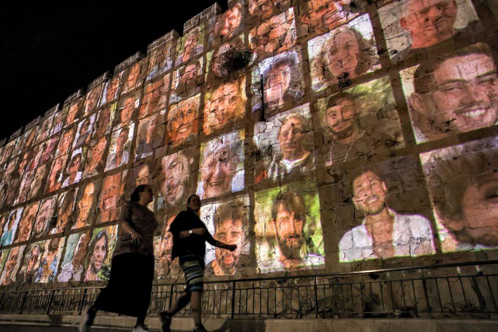 Pictures of the hostages are projected outside the walls of the old city of Jerusalem Nov. 6. Of 259 hostages, 28% are foreign nationals, including many who are not Jewish, according to the Israeli embassy in the U.S.