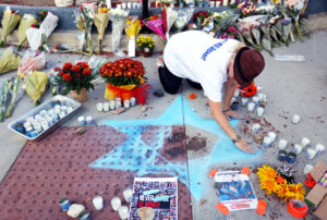 Elena Colombo draws a Star of David at a makeshift memorial to 69-year-old Paul Kessler, who died following an altercation with a pro-Palestinian protestor in Thousand Oaks, California.