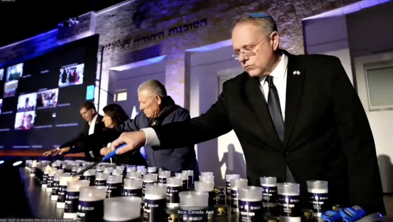 Participants in a ceremony in Jerusalem tied to shloshim, the 30-day mark after a Jewish death, light memorial candles on Sunday, Nov. 5, 2023. (Screenshot)