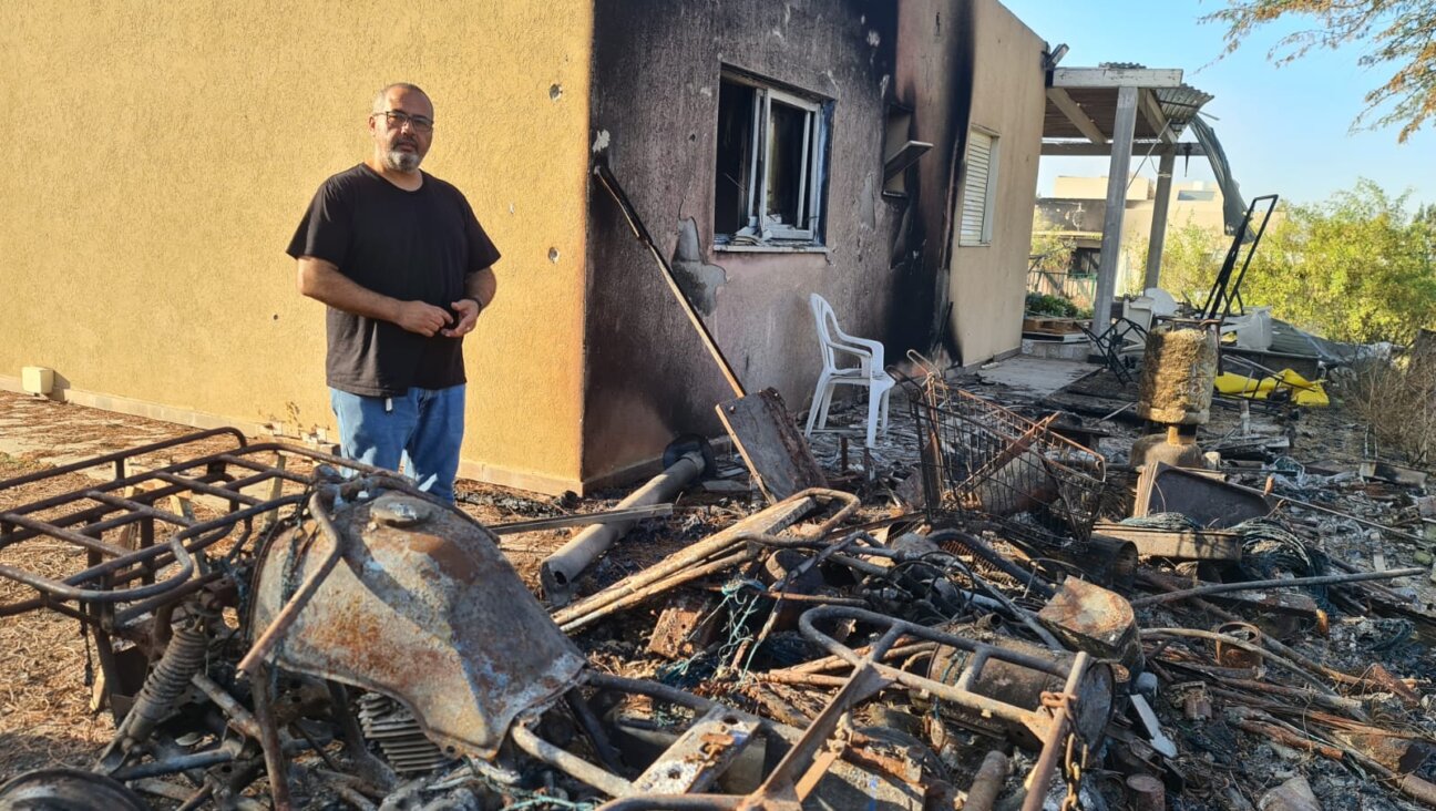 Gili Okev sits outside his ruined house in Kfar Aza, Israel, a month after Hamas terrorists invaded and killed many of his neighbors. He doesn’t know why he was spared. (Deborah Danan)
