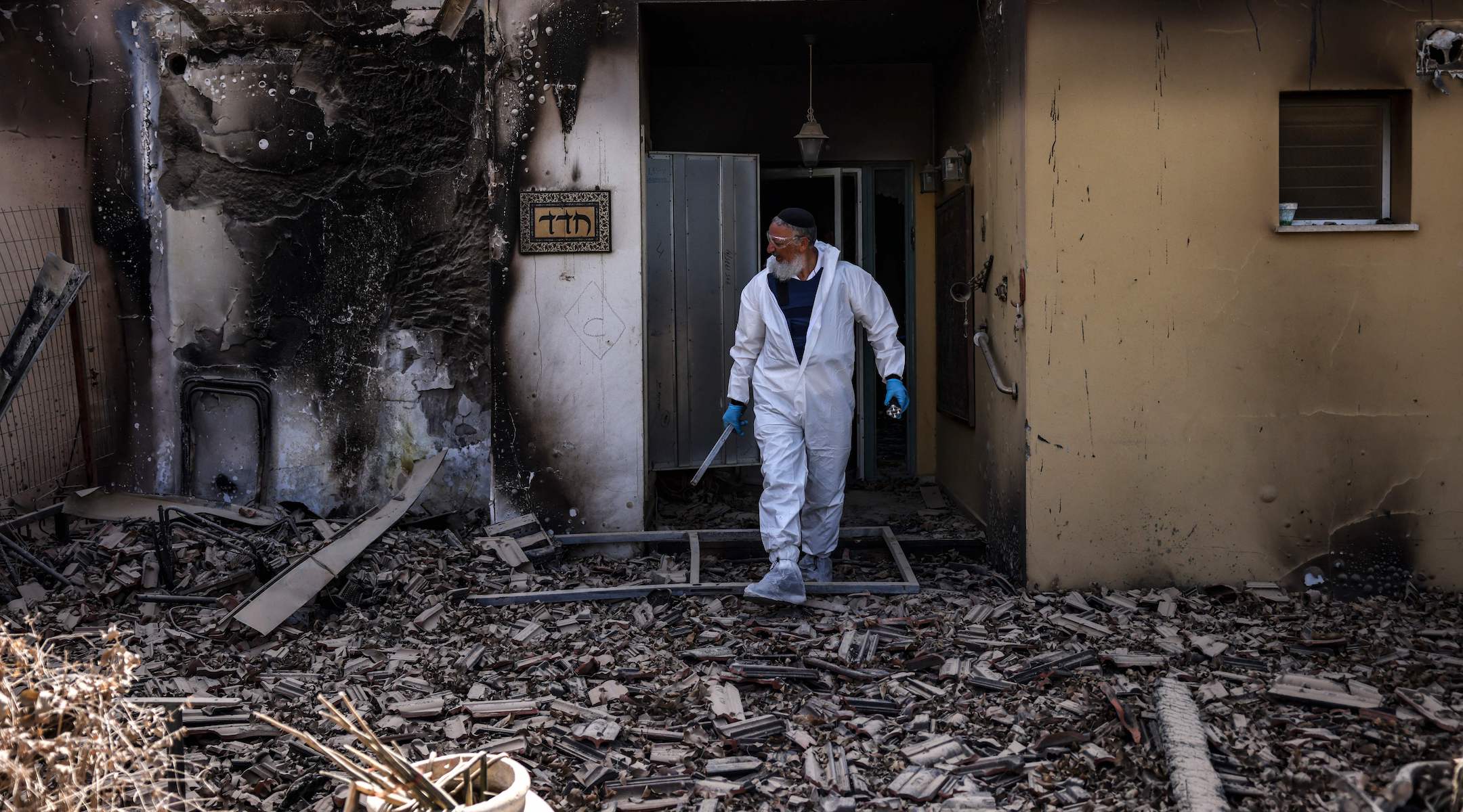 A haredi volunteer for the ZAKA emergency response service searches through the debris in Kibbutz Be’eri, near the border with Gaza, on October 20, 2023. (Ronaldo Schemidt/AFP via Getty Images)