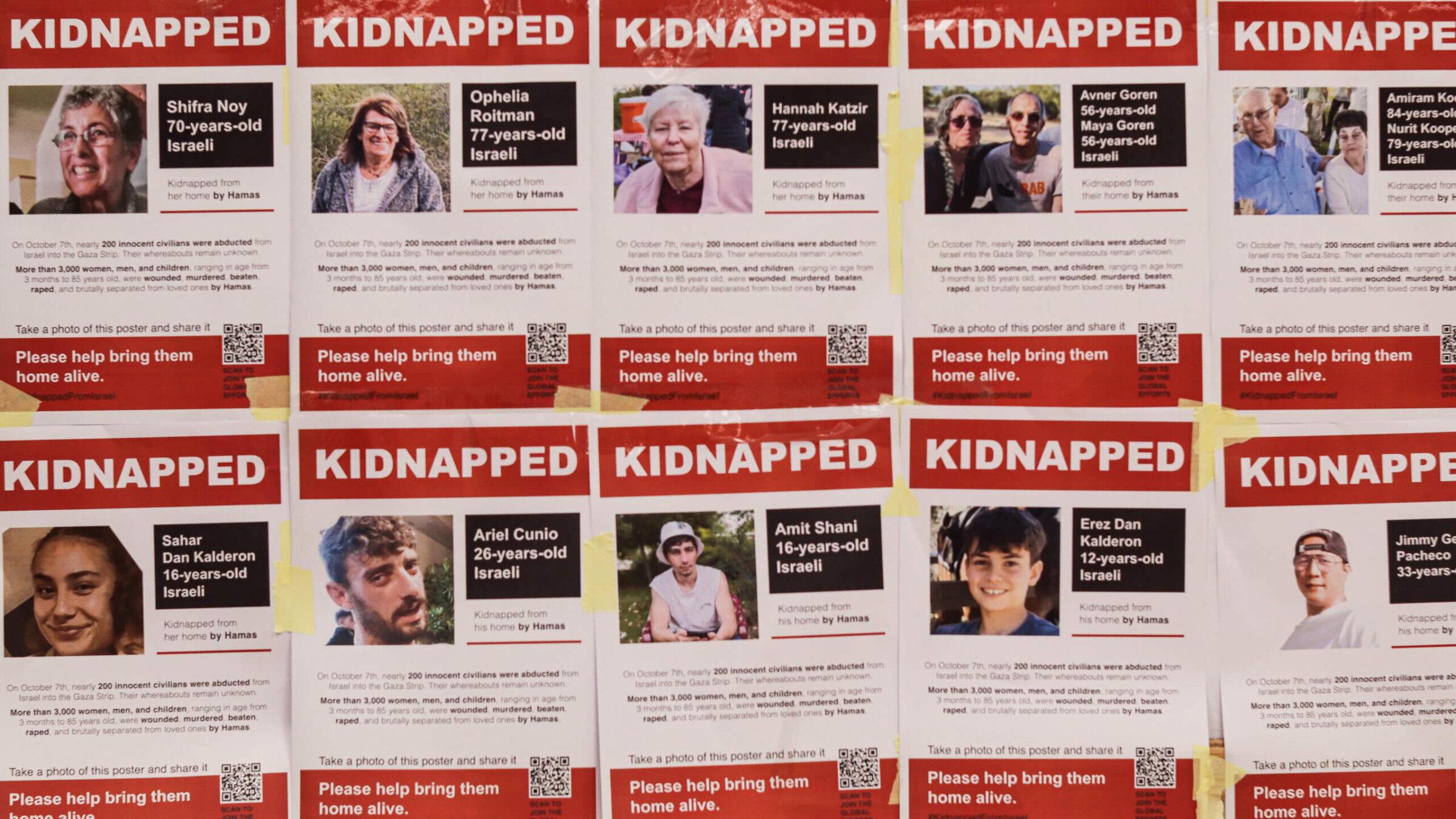 Posters showing the faces of Israeli citizens kidnapped by Hamas militants on the wall of a media office in Sderot, southern Israel, on Tuesday, Oct. 17, 2023. 