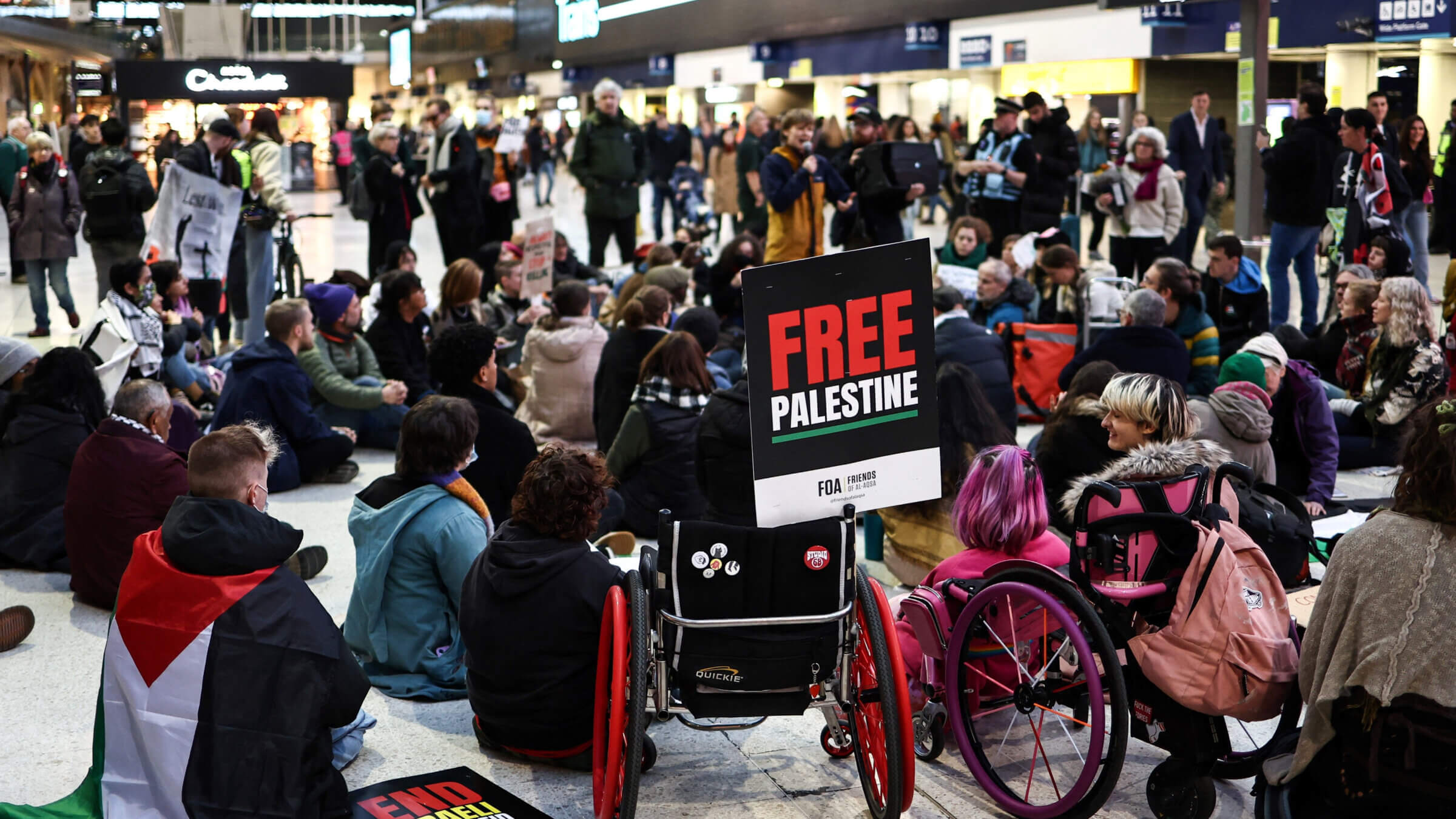 Protesters take part in a sit-in protest at Waterloo station on the sideline of the 'National March For Palestine' in central London on Nov. 11, 2023