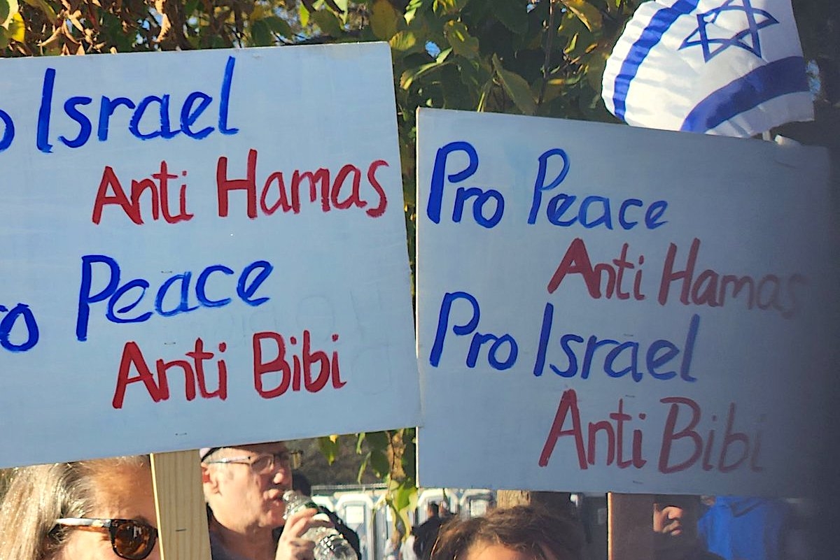 Signs held by members of the “peace bloc” who attended at the March for Israel in Washington, D.C., Nov. 14, 2023. (JTA)