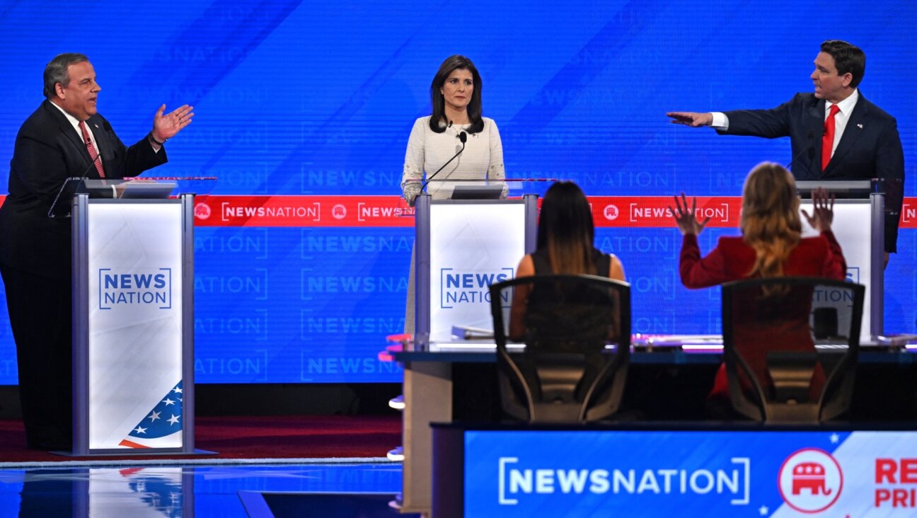 Former Governor from South Carolina Nikki Haley looks on as Florida Governor Ron DeSantis, right, and former Governor of New Jersey Chris Christie, left, gesture toward each other as they speak during the fourth Republican presidential primary debate at the University of Alabama in Tuscaloosa, Alabama, Dec. 6, 2023. Jim Watson / AFP/Getty Images)