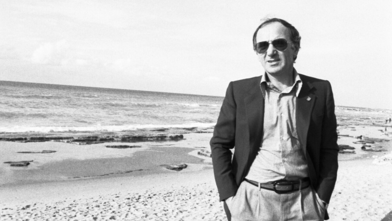 Charles Aznavour on a beach in Jaffa, Israel, January 1977. (William Karel/Gamma-Rapho via Getty Images)