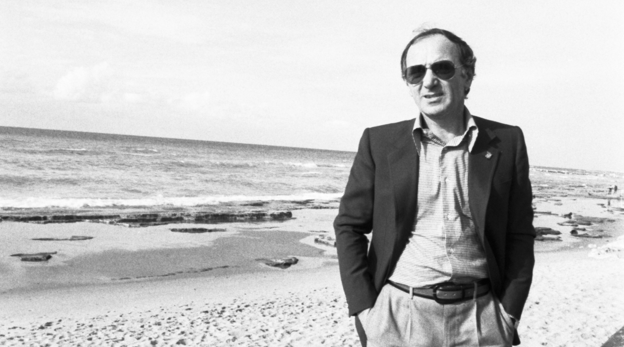 Charles Aznavour on a beach in Jaffa, Israel, January 1977. (William Karel/Gamma-Rapho via Getty Images)