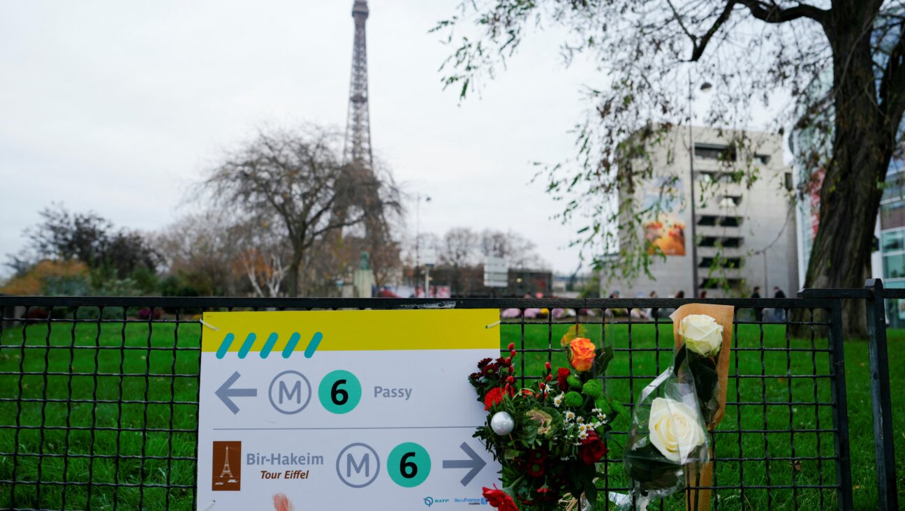 Flowers are displayed near where a tourist was stabbed to death near the Eiffel Tower on Dec. 2, 2023.