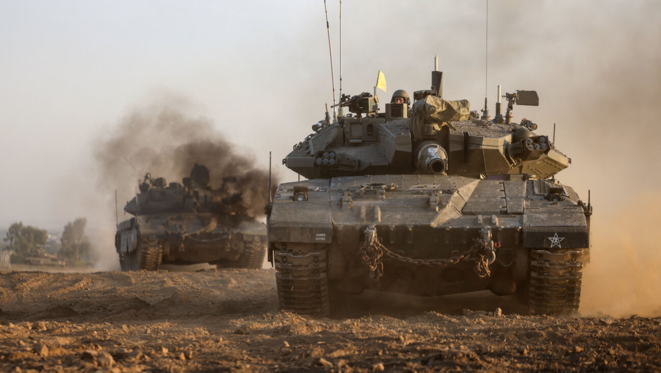  Israeli military tanks roll near the border with the Gaza Strip.