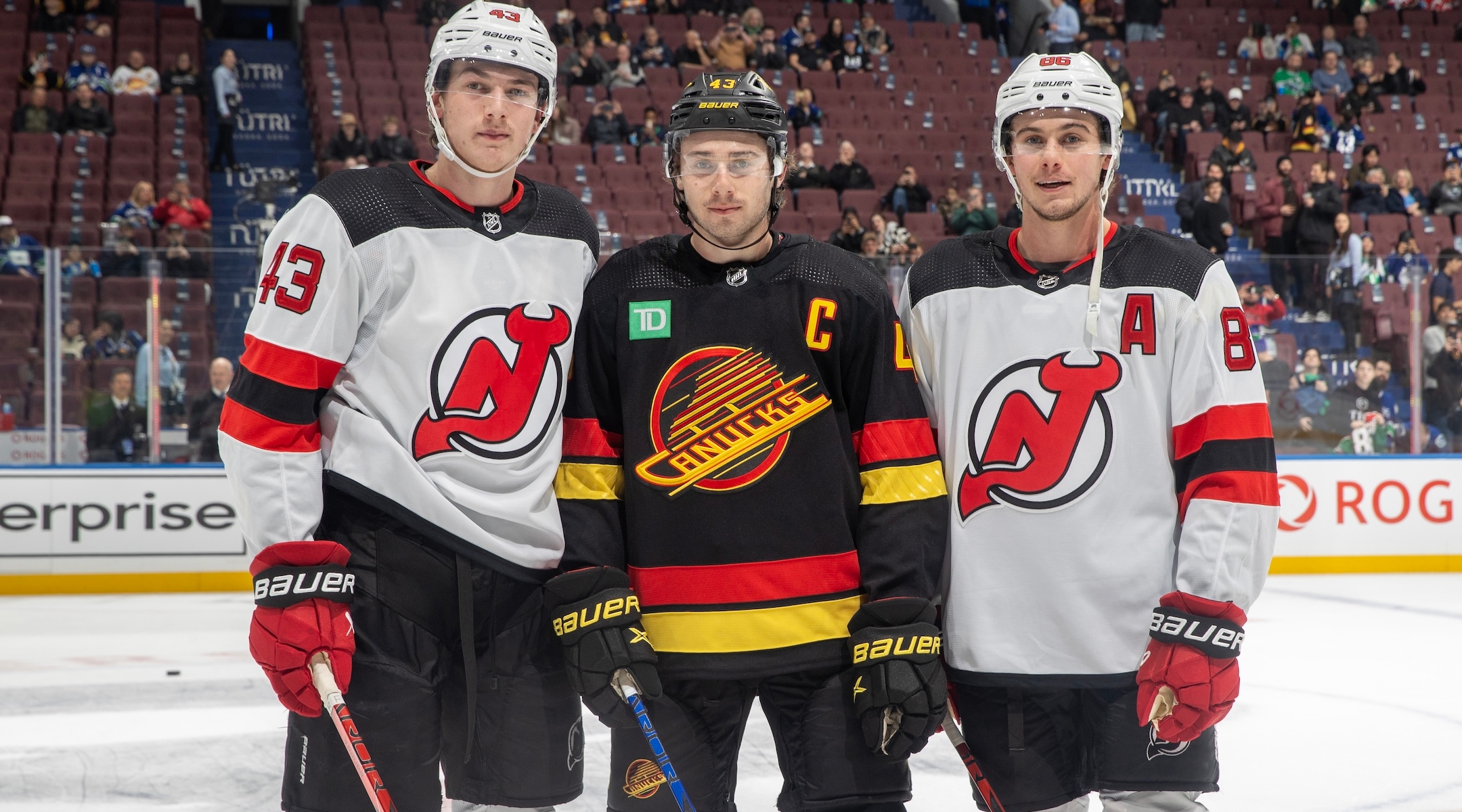 From left to right: Luke, Quinn and Jack Hughes pose for a photo before their NHL game at Rogers Arena in Vancouver, Dec. 5, 2023. (Jeff Vinnick/NHLI via Getty Images)