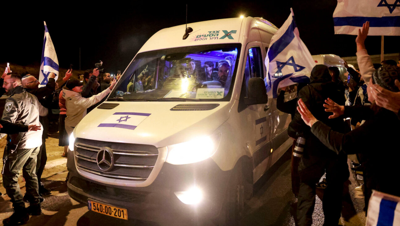 Supporters welcome Israeli hostages as they arrive at Ofakim army base in southern Israel early on Thursday.