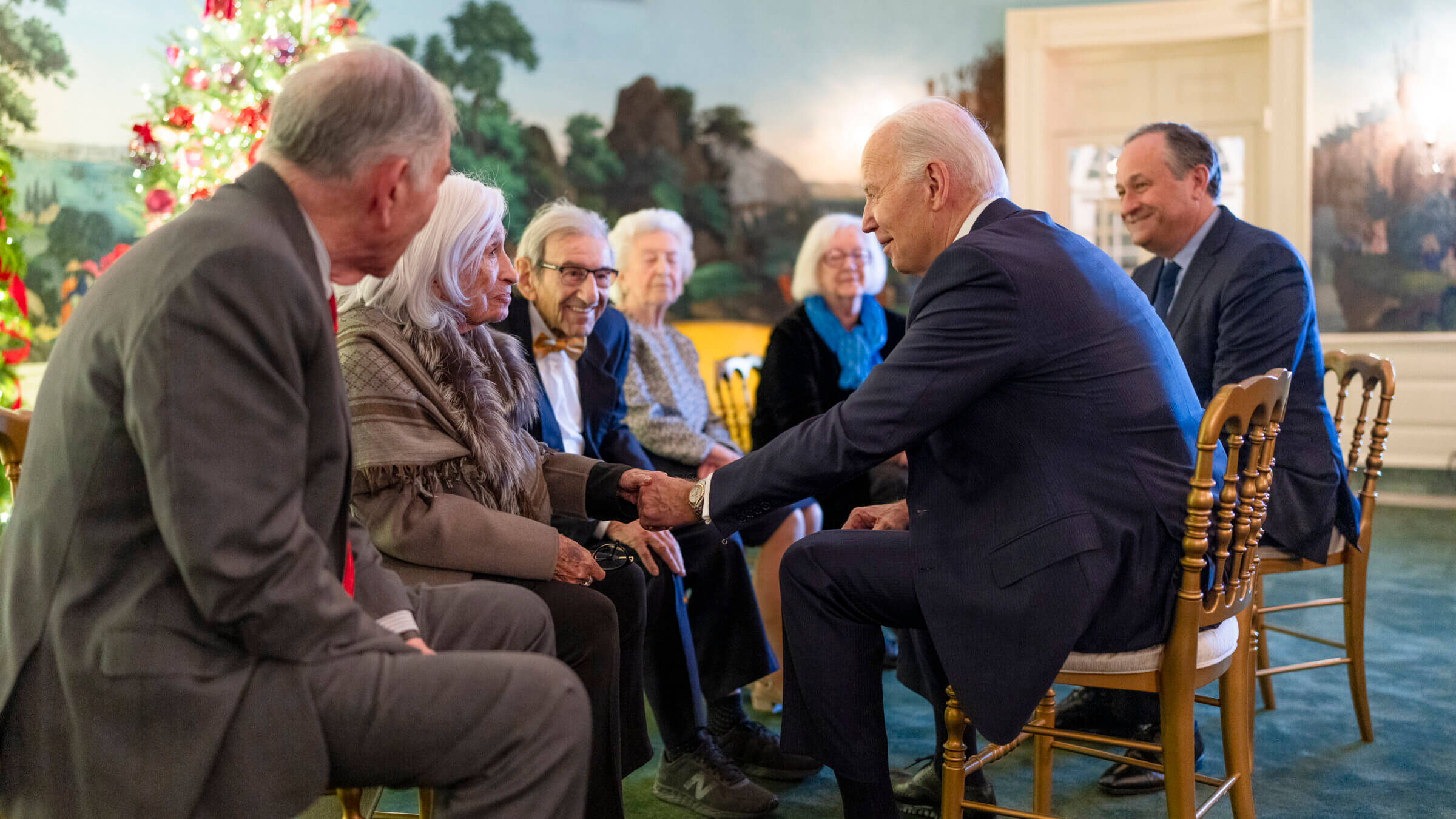 President Joe Biden greets a group of Holocaust survivors  — including Saul Dreier, wearing a bowtie — before the Hanukkah reception on Dec. 11. 