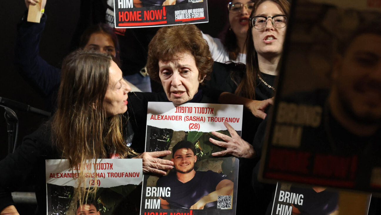 Irena Tati, a released Russian-Israeli hostage, holds a picture of her 27-year-old grandson  Alexander (Sasha) Trufanov during a Saturday night demonstration in Tel Aviv. 