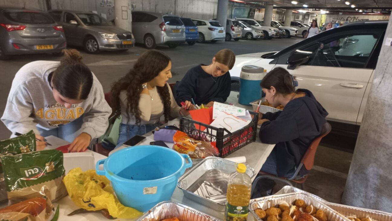 Students volunteer in their school's parking garage, which also is functioning as a kitchen.