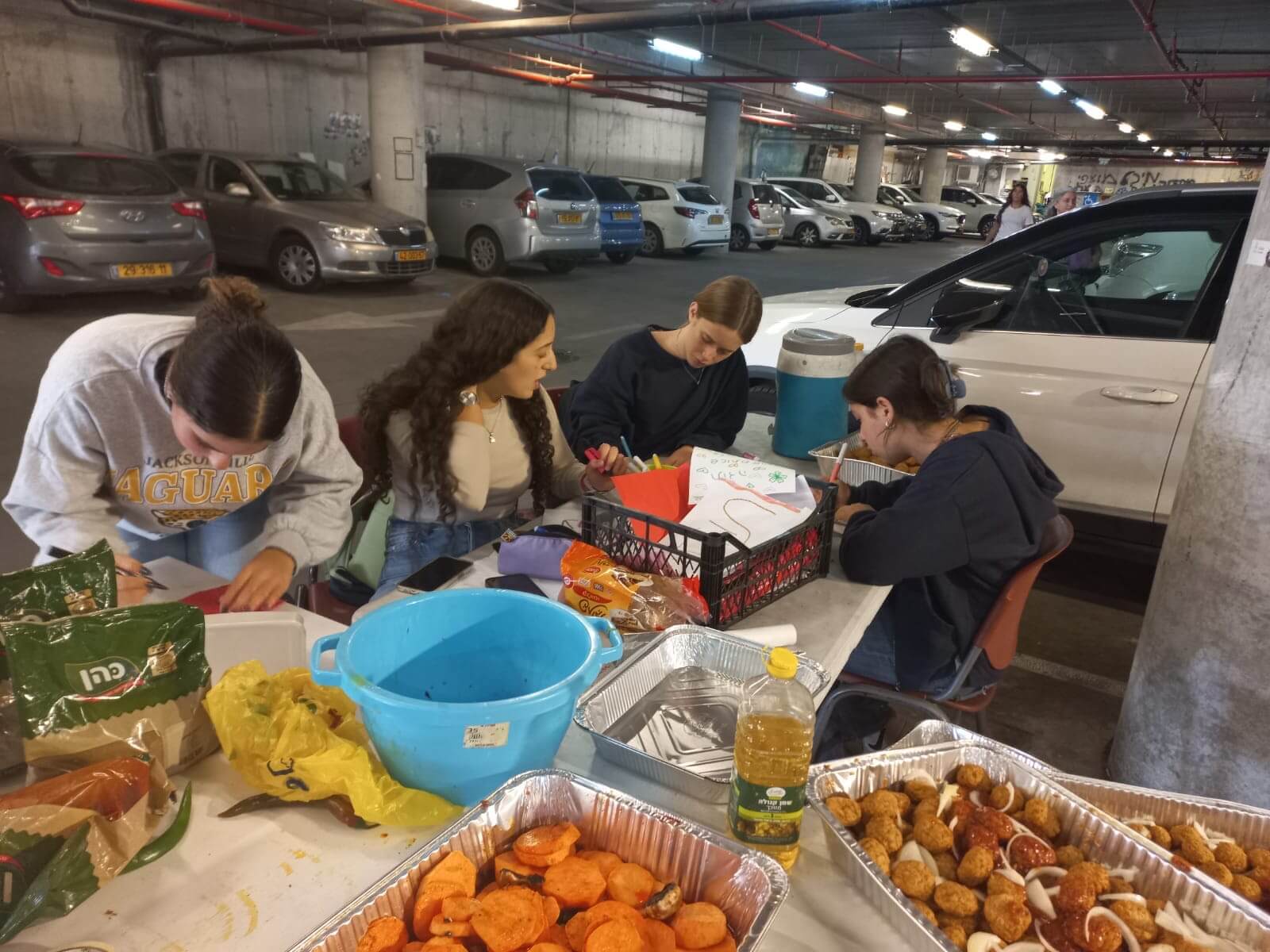 Students volunteer in their school's parking garage, which also is functioning as a kitchen.