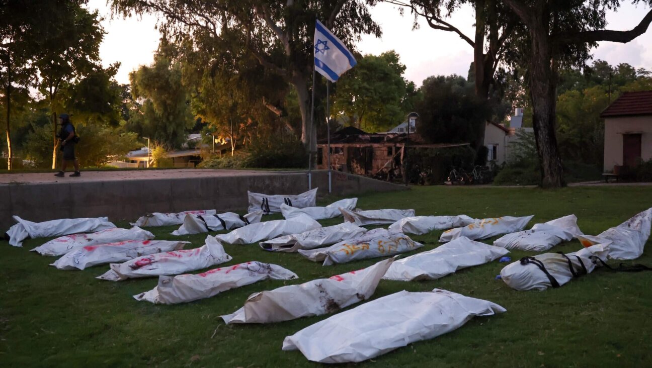 Covered bodies at Kibbutz Be'eri near the border with Gaza. Sahar Baruch was kidnapped and his brother murdered in a Hamas attack there. 